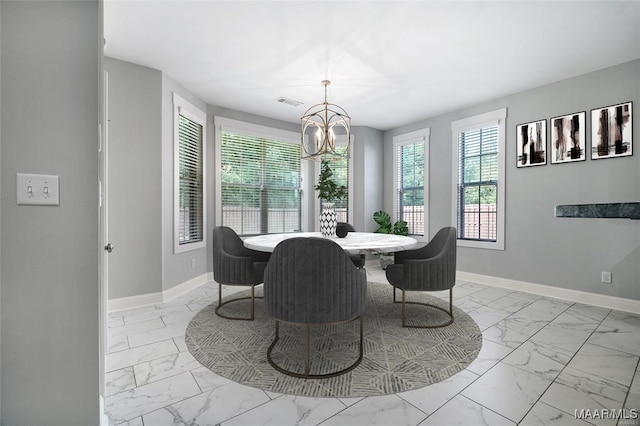 dining area featuring an inviting chandelier