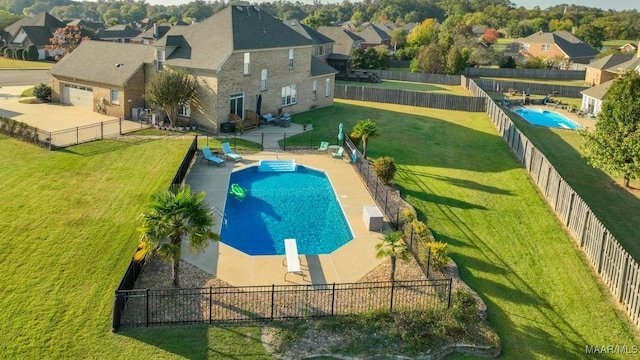 view of pool with a lawn and a diving board