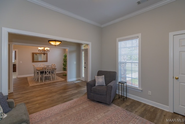 living area featuring hardwood / wood-style flooring, crown molding, and a wealth of natural light