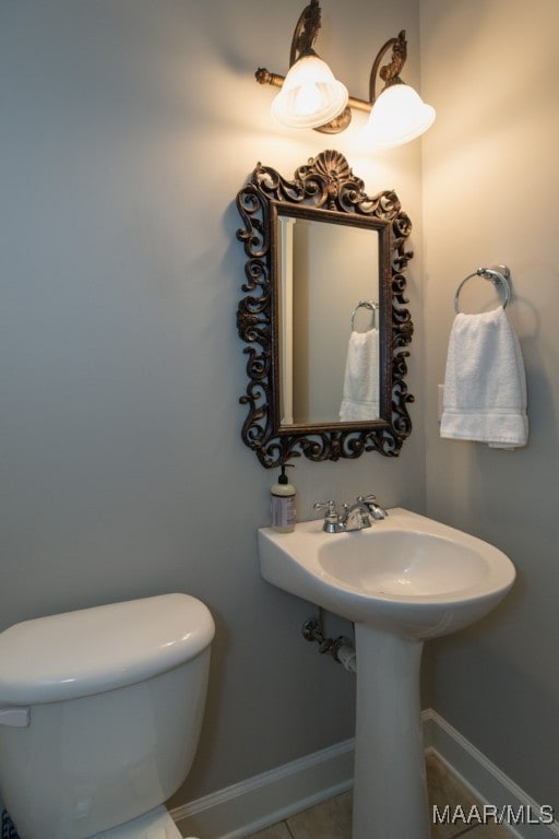 bathroom with tile patterned floors, toilet, and sink