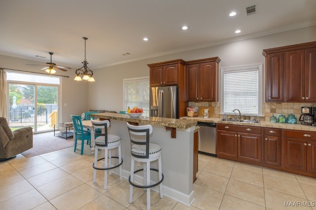 kitchen featuring a center island, stainless steel appliances, backsplash, and sink