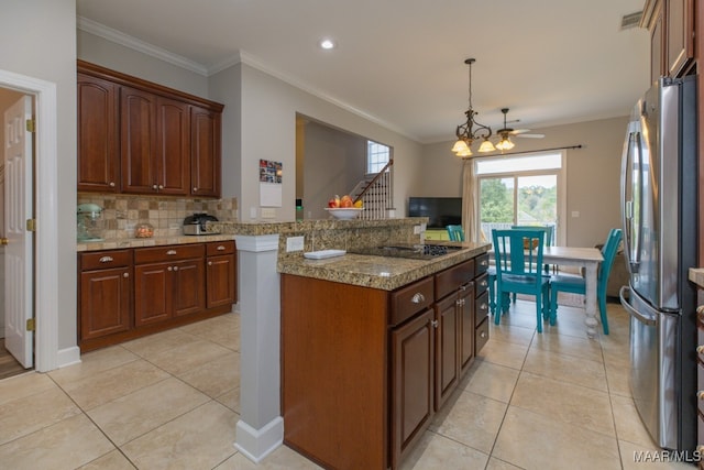 kitchen featuring stainless steel fridge, light stone counters, light tile patterned floors, and crown molding