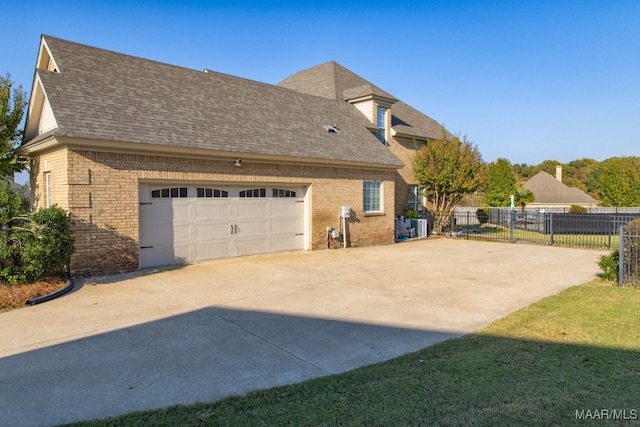 view of side of home with a garage and a yard