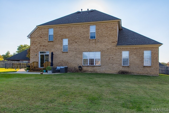 back of property with a lawn and central AC