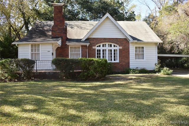 view of front facade with a front yard and a carport