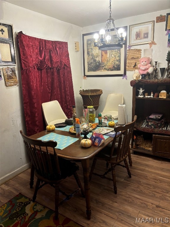 dining room with a chandelier and wood-type flooring