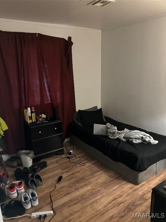 bedroom with wood-type flooring