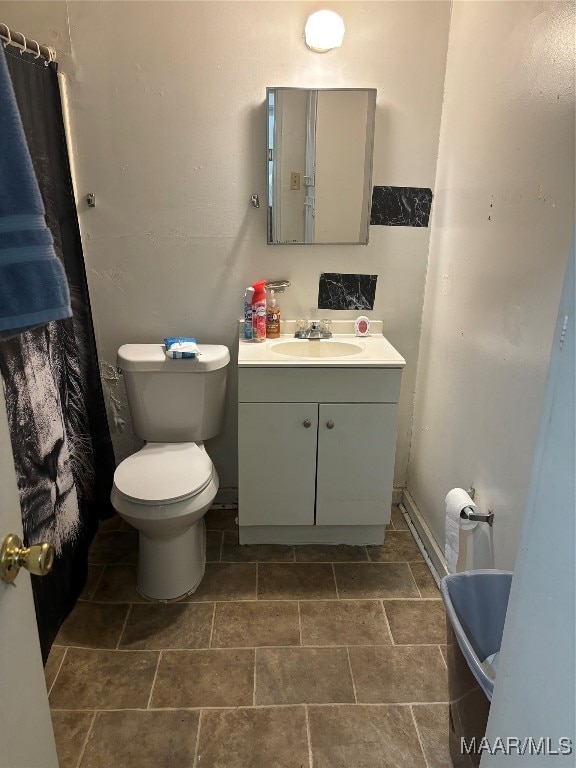 bathroom featuring vanity and toilet