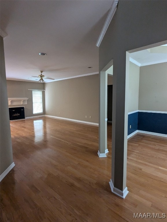 unfurnished room with hardwood / wood-style floors, ceiling fan, and crown molding