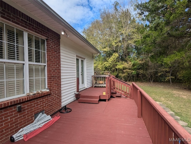 wooden terrace featuring a yard