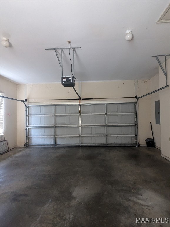 garage featuring electric panel and a garage door opener