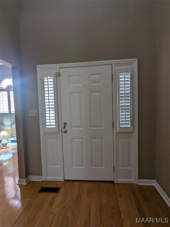 entrance foyer with plenty of natural light and wood-type flooring