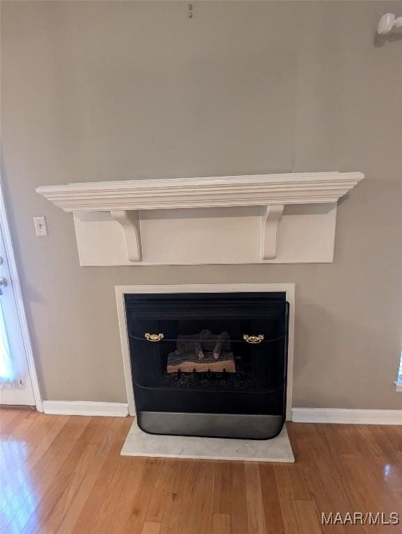 106 Crown Ridge Dr, Selma, AL 36701 - detailed view of wood finished floors, baseboards, and a fireplace