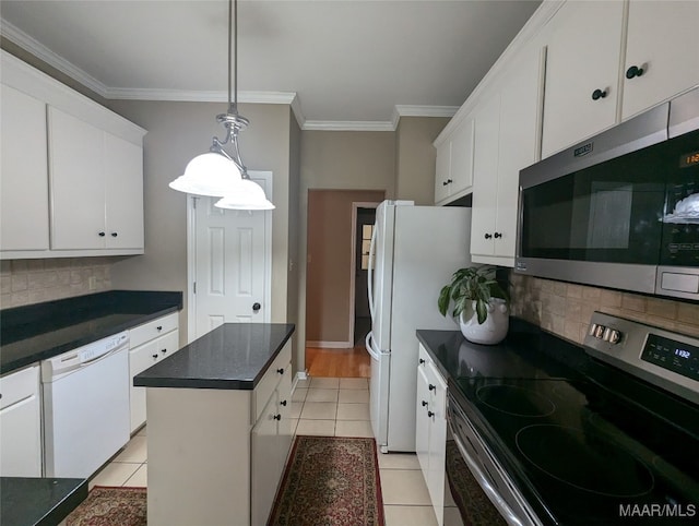 kitchen with stainless steel appliances, light tile patterned floors, a kitchen island, tasteful backsplash, and white cabinets