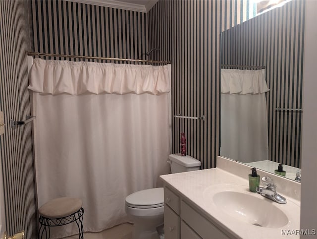 bathroom with vanity, toilet, and ornamental molding