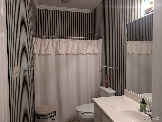 bathroom with toilet, vanity, and ornamental molding