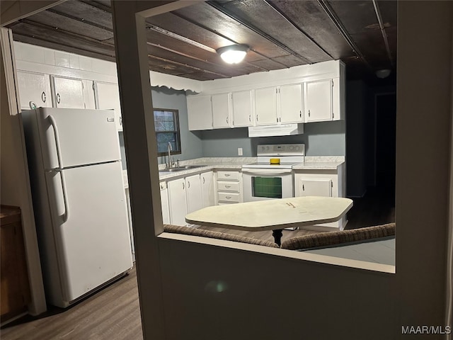 kitchen with white cabinetry, hardwood / wood-style flooring, white appliances, and ventilation hood