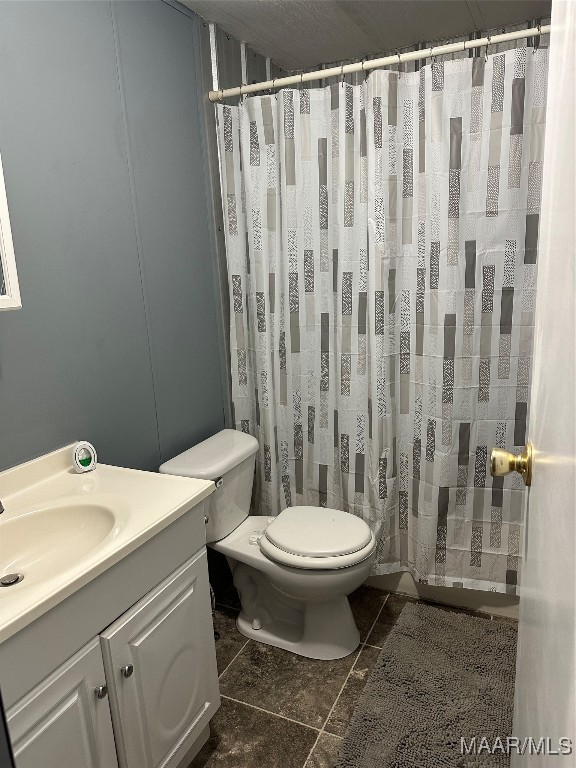 bathroom with tile patterned flooring, vanity, and toilet