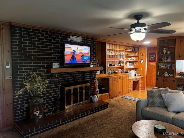 10521 US Highway 31, Hope Hull, AL 36043 - carpeted living area with ceiling fan, a fireplace, wood walls, and crown molding
