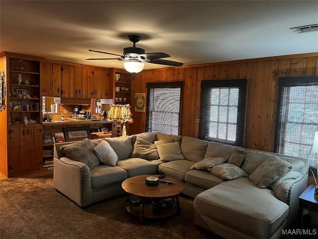 10521 US Highway 31, Hope Hull, AL 36043 - carpeted living room with wood walls and ceiling fan