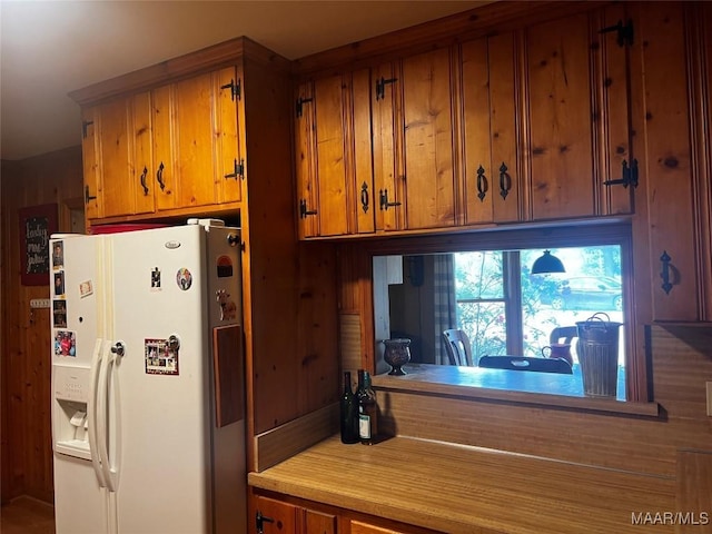 10521 US Highway 31, Hope Hull, AL 36043 - kitchen featuring white refrigerator with ice dispenser, brown cabinetry, and light countertops