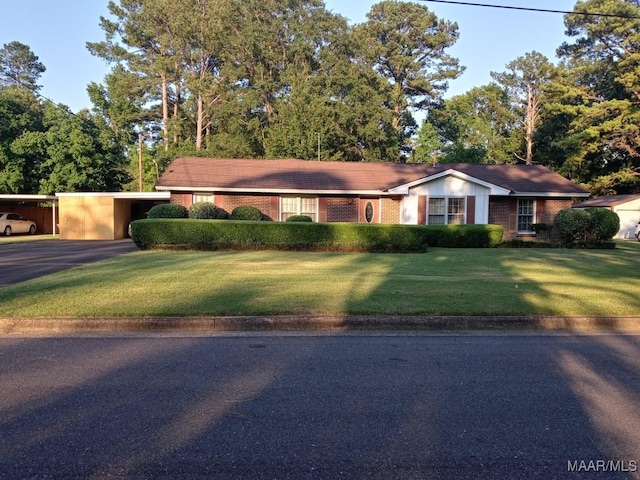 single story home featuring a carport and a front lawn