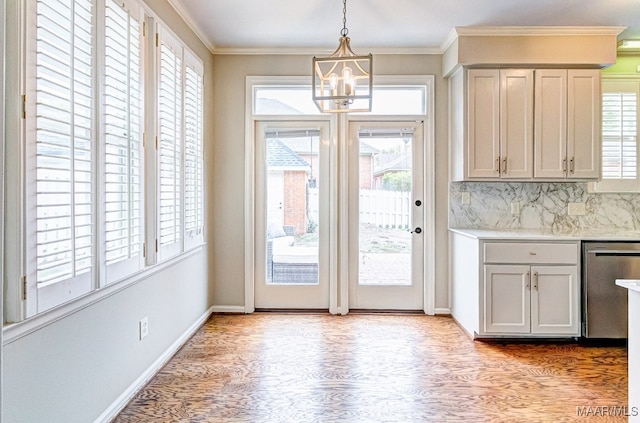 doorway to outside featuring light wood-type flooring, baseboards, and ornamental molding