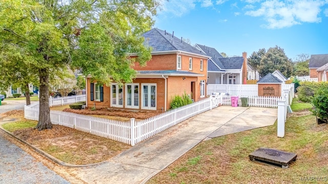 view of front facade featuring fence private yard and brick siding