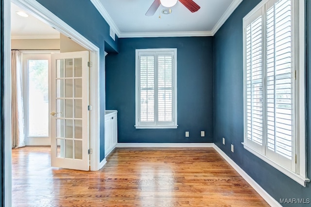 unfurnished room with wood finished floors and crown molding