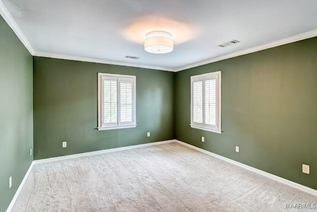 spare room featuring a healthy amount of sunlight, visible vents, and ornamental molding