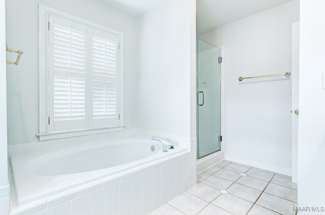 bathroom with tile patterned flooring, a shower stall, and a bath