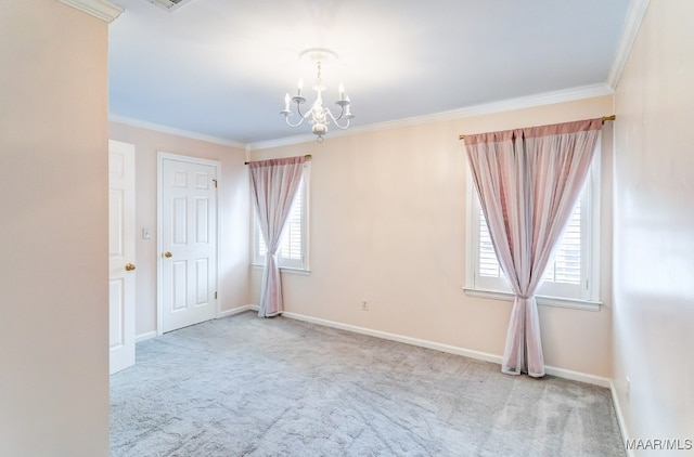 carpeted spare room featuring ornamental molding, a notable chandelier, and baseboards