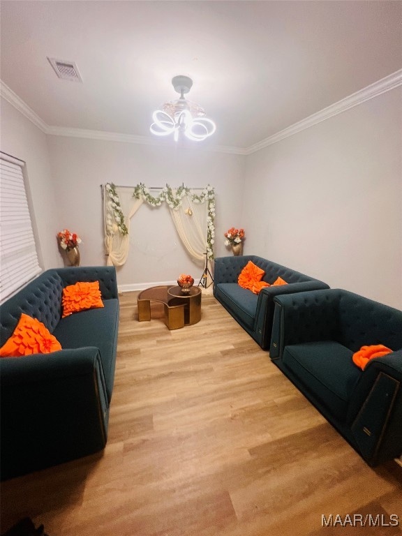 living room with crown molding and hardwood / wood-style flooring