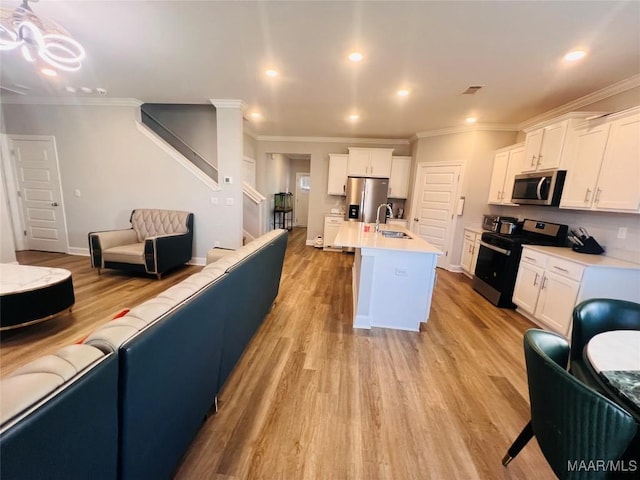 kitchen featuring white cabinetry, an island with sink, appliances with stainless steel finishes, and sink