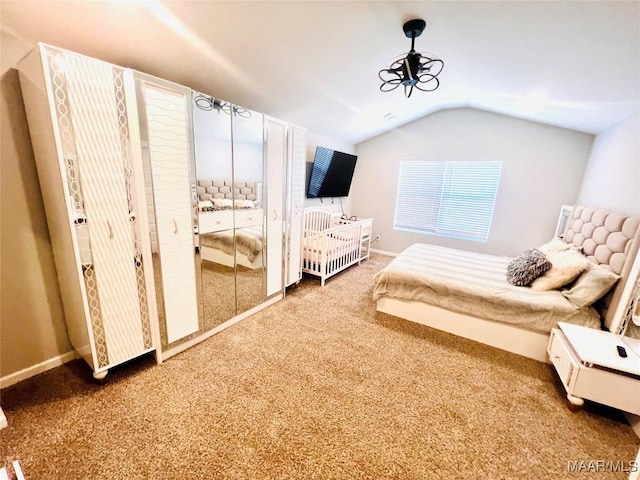 unfurnished bedroom with vaulted ceiling and carpet floors