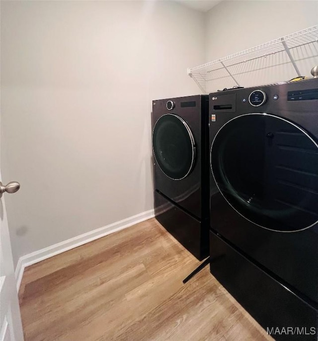 laundry area featuring hardwood / wood-style floors and independent washer and dryer