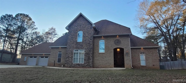 view of front of property with a garage and a front lawn