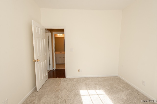 unfurnished room featuring light colored carpet