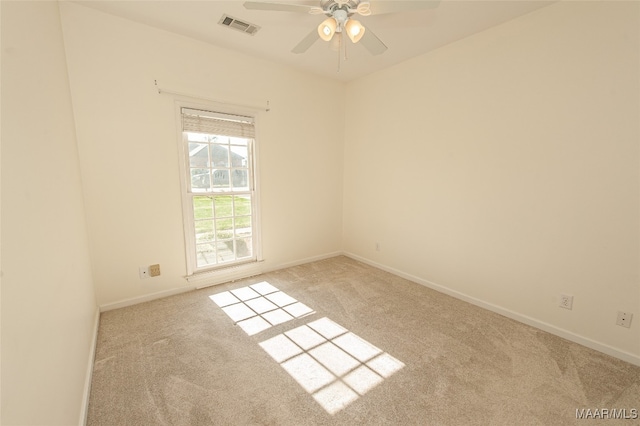 carpeted empty room featuring ceiling fan