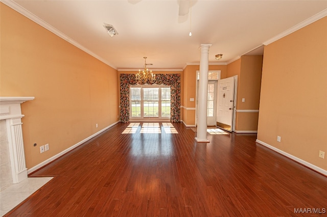 unfurnished living room with hardwood / wood-style flooring, ornate columns, and crown molding