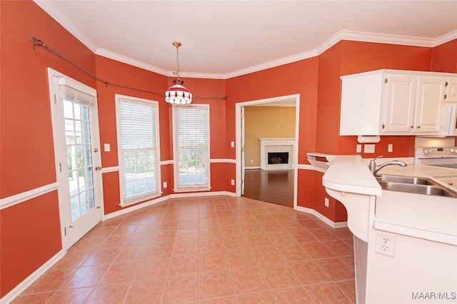 kitchen with pendant lighting, white range, white cabinetry, and crown molding