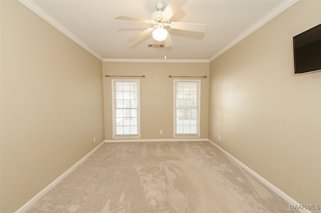 spare room featuring light carpet, ceiling fan, and ornamental molding