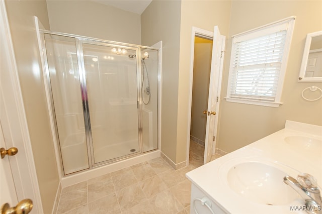 bathroom featuring a shower with door and sink