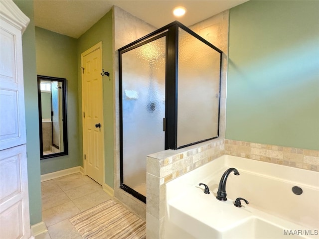 bathroom with independent shower and bath and tile patterned flooring