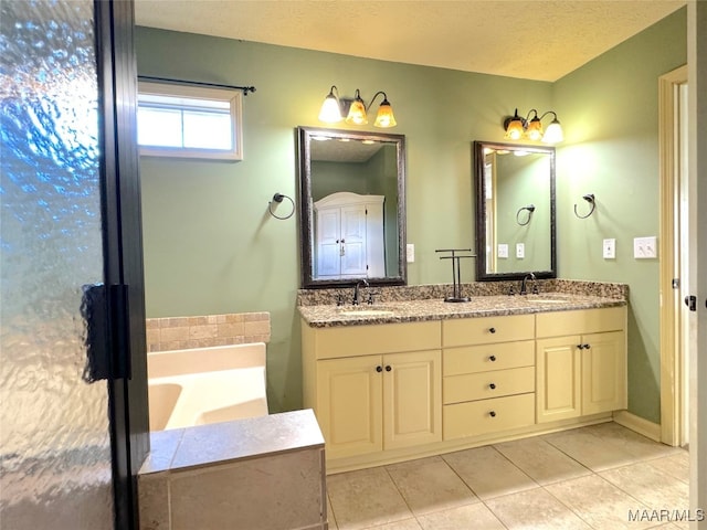 bathroom featuring vanity, tile patterned flooring, and a bathing tub