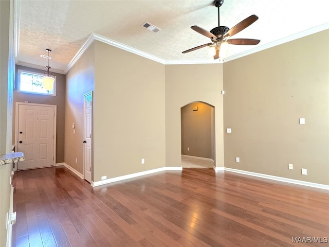 entryway with ceiling fan, hardwood / wood-style flooring, ornamental molding, and a textured ceiling