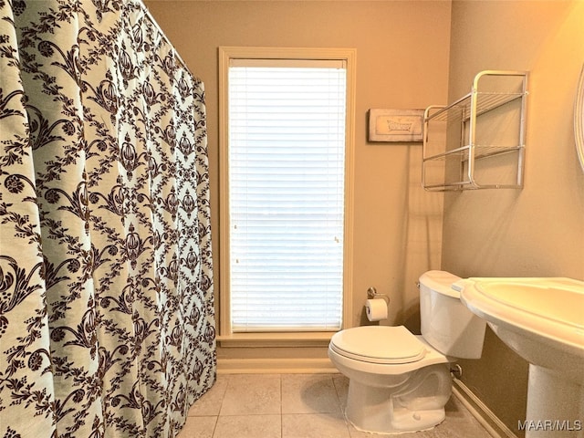 bathroom featuring tile patterned flooring and toilet