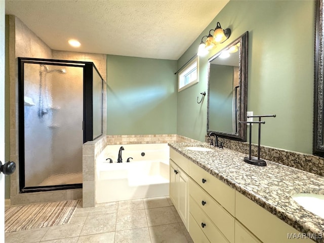 bathroom with tile patterned flooring, vanity, separate shower and tub, and a textured ceiling