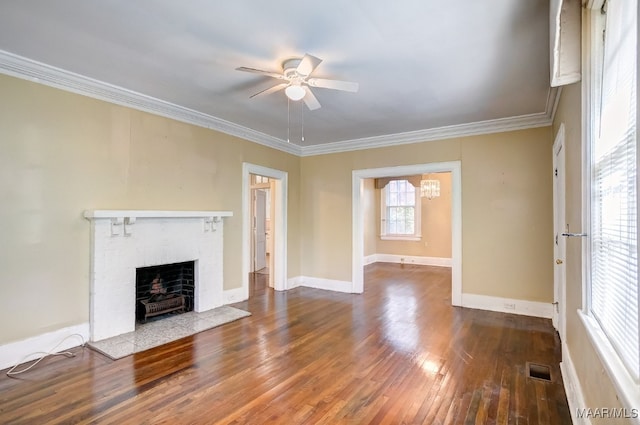 unfurnished living room with a fireplace, hardwood / wood-style floors, ceiling fan with notable chandelier, and ornamental molding