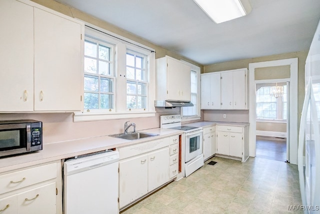 kitchen featuring white cabinetry, sink, extractor fan, and white appliances